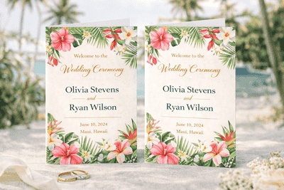 Destination wedding programs printing with tropical floral design displayed on beach setting with palm trees and wedding rings